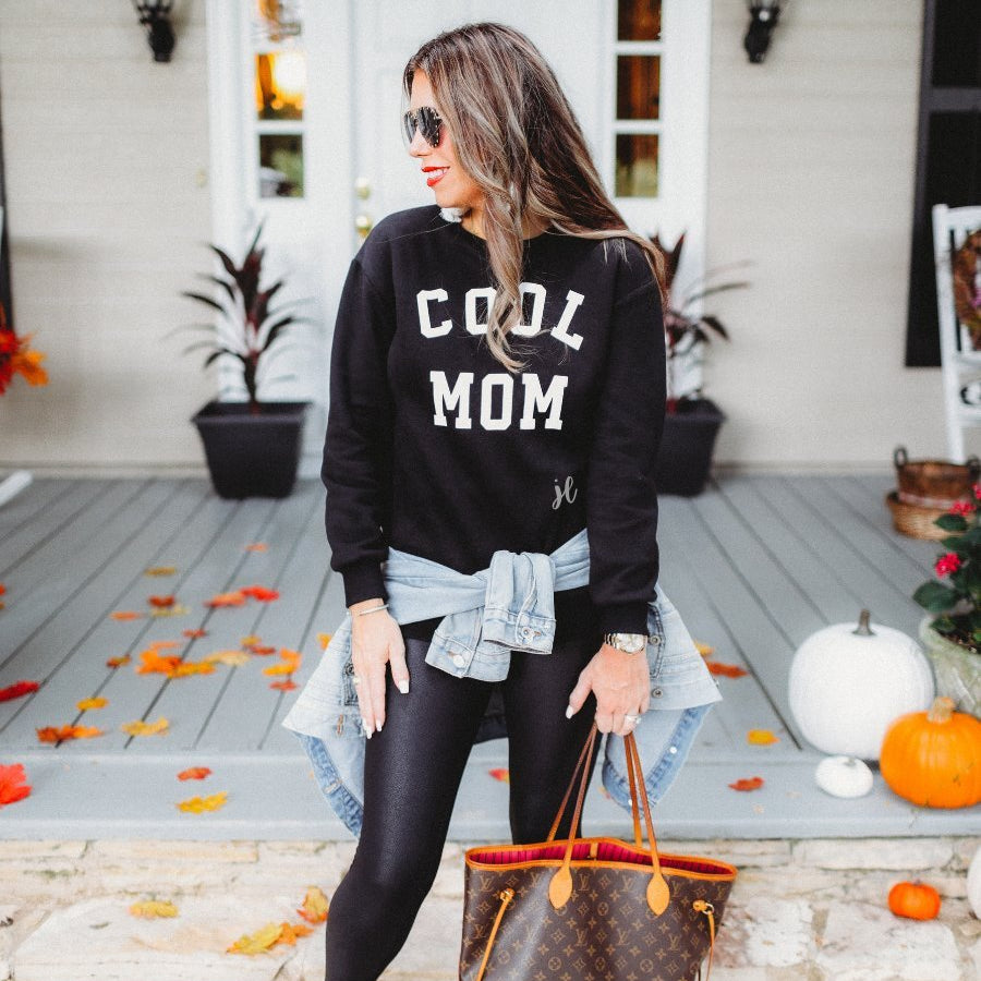 long-sleeve sweatshirt with ultra soft fleece interior, a crew neckline, and bold white 'COOL MOM' block lettering