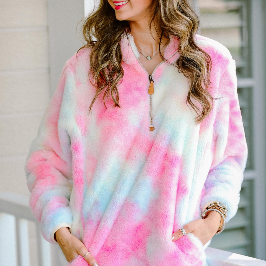 a long-sleeve plush pullover with a quarter zip, front pockets, and a foldable collar on a super soft tie-dye fabric