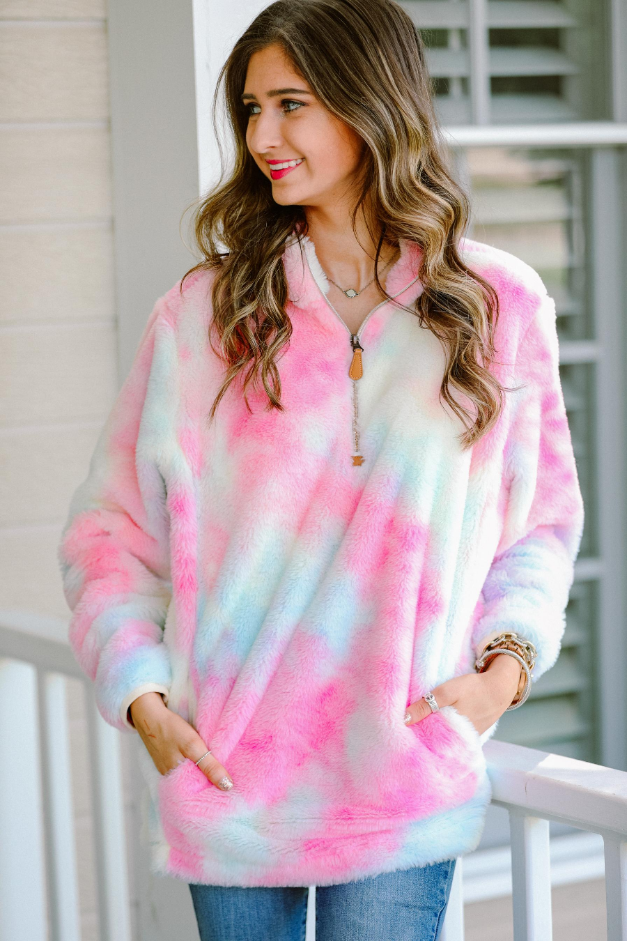 a long-sleeve plush pullover with a quarter zip, front pockets, and a foldable collar on a super soft tie-dye fabric