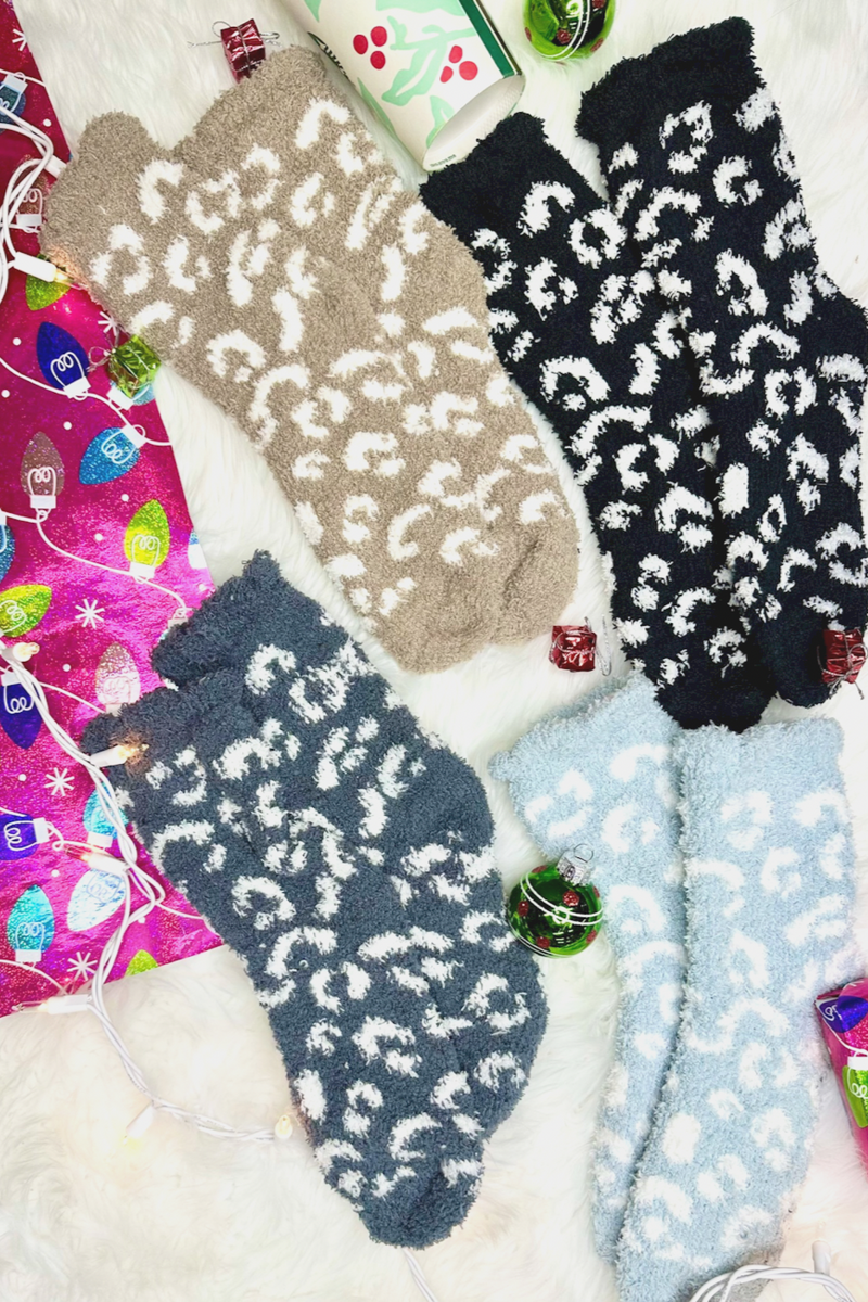 ultra-soft fuzzy socks with a playful animal print in black, blue, grey, and tan