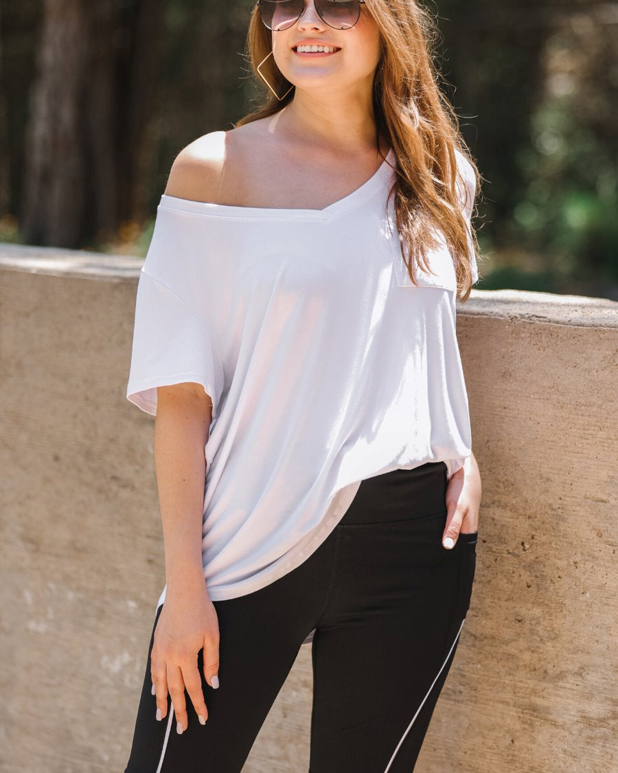 sleek black biker shorts created from lightweight stretch fabric with a white piping, high elastic waistband for tummy control, side pockets, a flattering figure-hugging short silhouette, above-knee length, and pull-on design