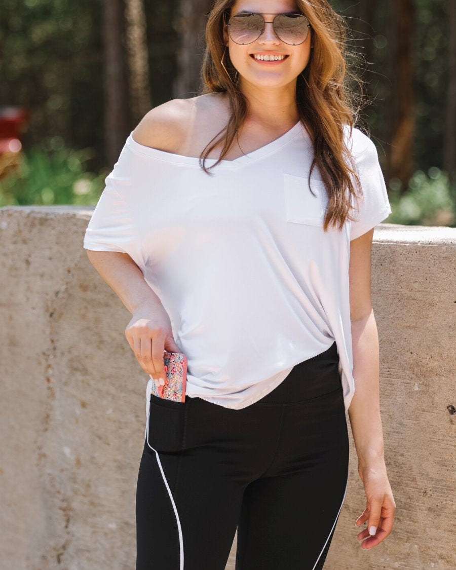 sleek black biker shorts created from lightweight stretch fabric with a white piping, high elastic waistband for tummy control, side pockets, a flattering figure-hugging short silhouette, above-knee length, and pull-on design
