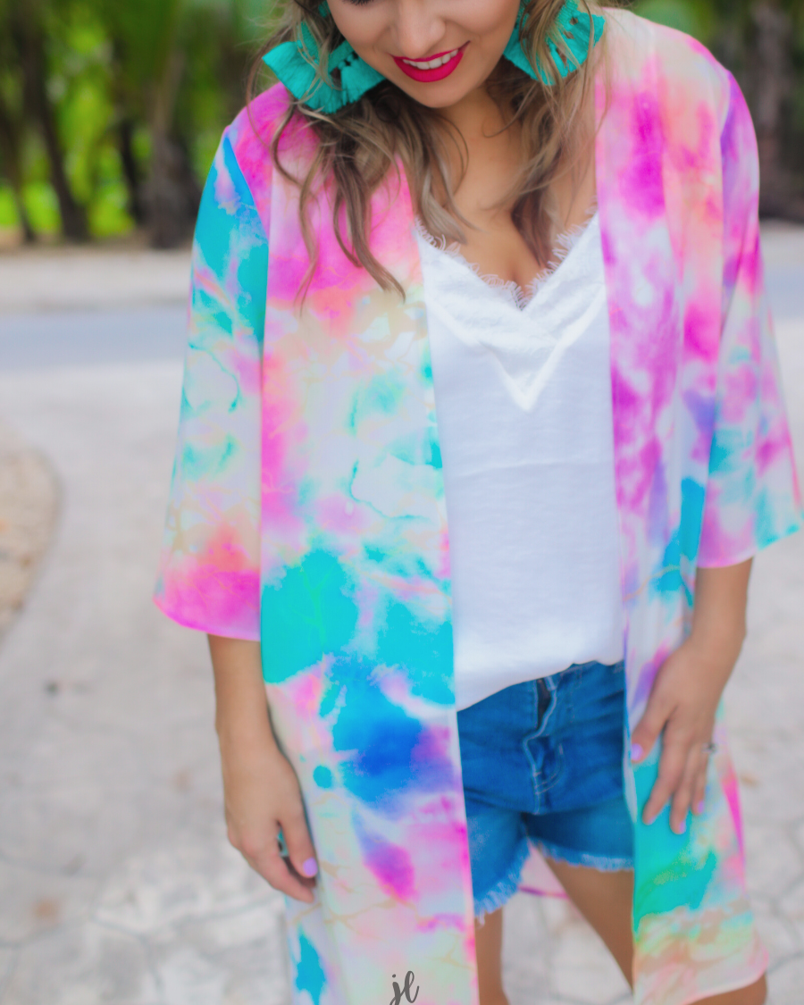 half-sleeve open front kimono made of lightweight material with a relaxed fit on a multi-colored tie-dye print pattern fabric