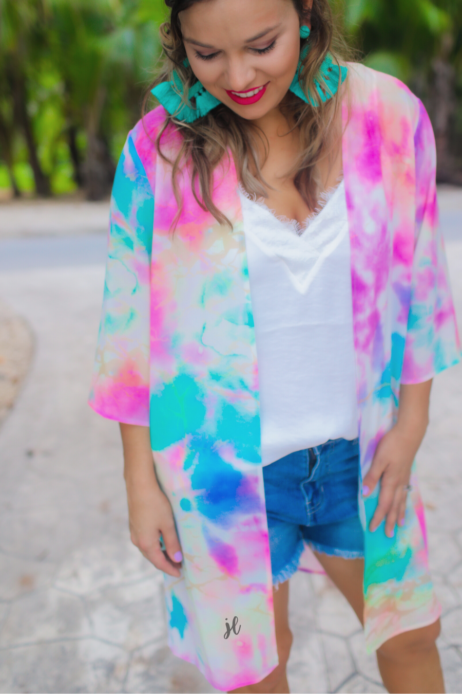 half-sleeve open front kimono made of lightweight material with a relaxed fit on a multi-colored tie-dye print pattern fabric