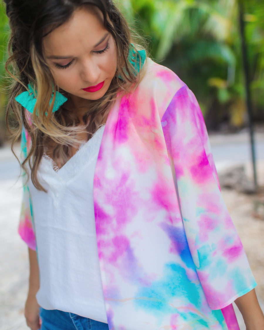 half-sleeve open front kimono made of lightweight material with a relaxed fit on a multi-colored tie-dye print pattern fabric