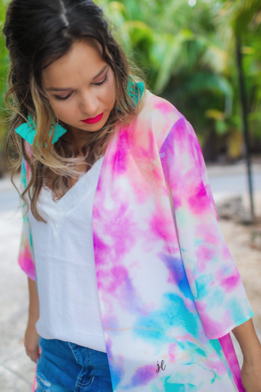 half-sleeve open front kimono made of lightweight material with a relaxed fit on a multi-colored tie-dye print pattern fabric
