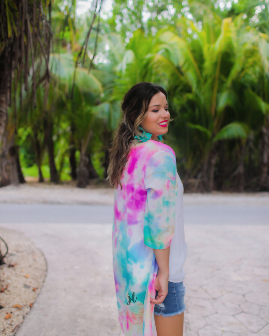 half-sleeve open front kimono made of lightweight material with a relaxed fit on a multi-colored tie-dye print pattern fabric