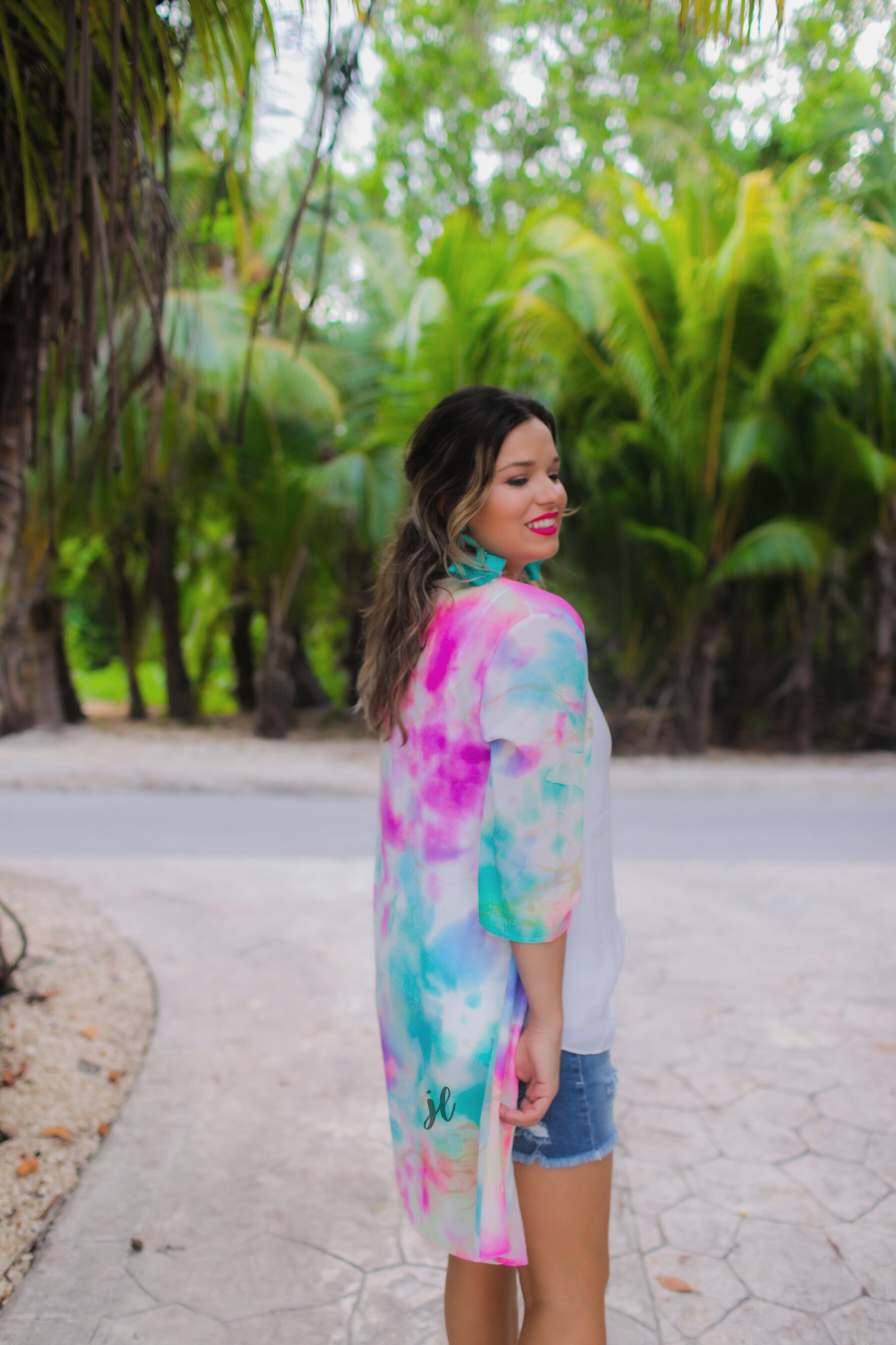 half-sleeve open front kimono made of lightweight material with a relaxed fit on a multi-colored tie-dye print pattern fabric