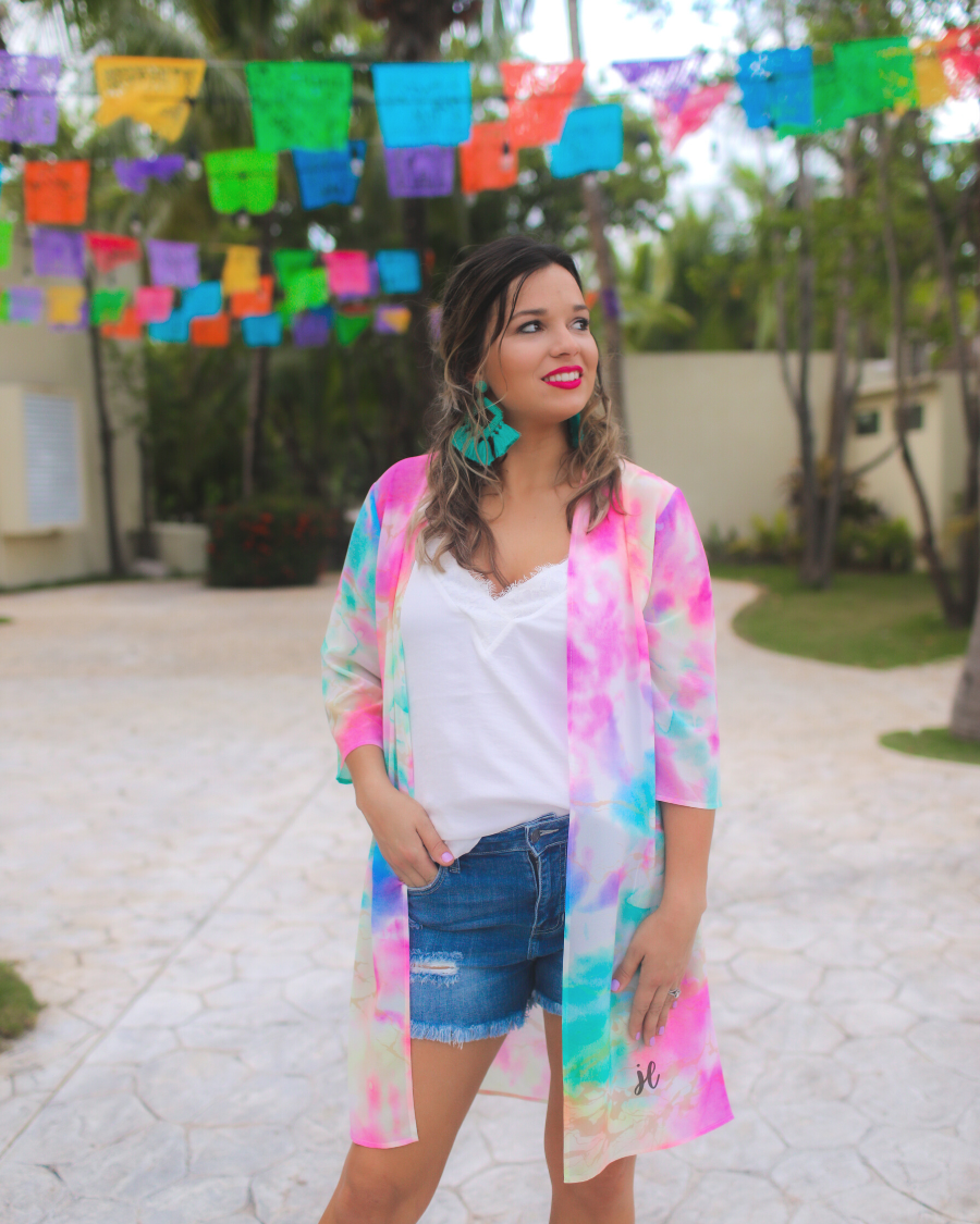 half-sleeve open front kimono made of lightweight material with a relaxed fit on a multi-colored tie-dye print pattern fabric