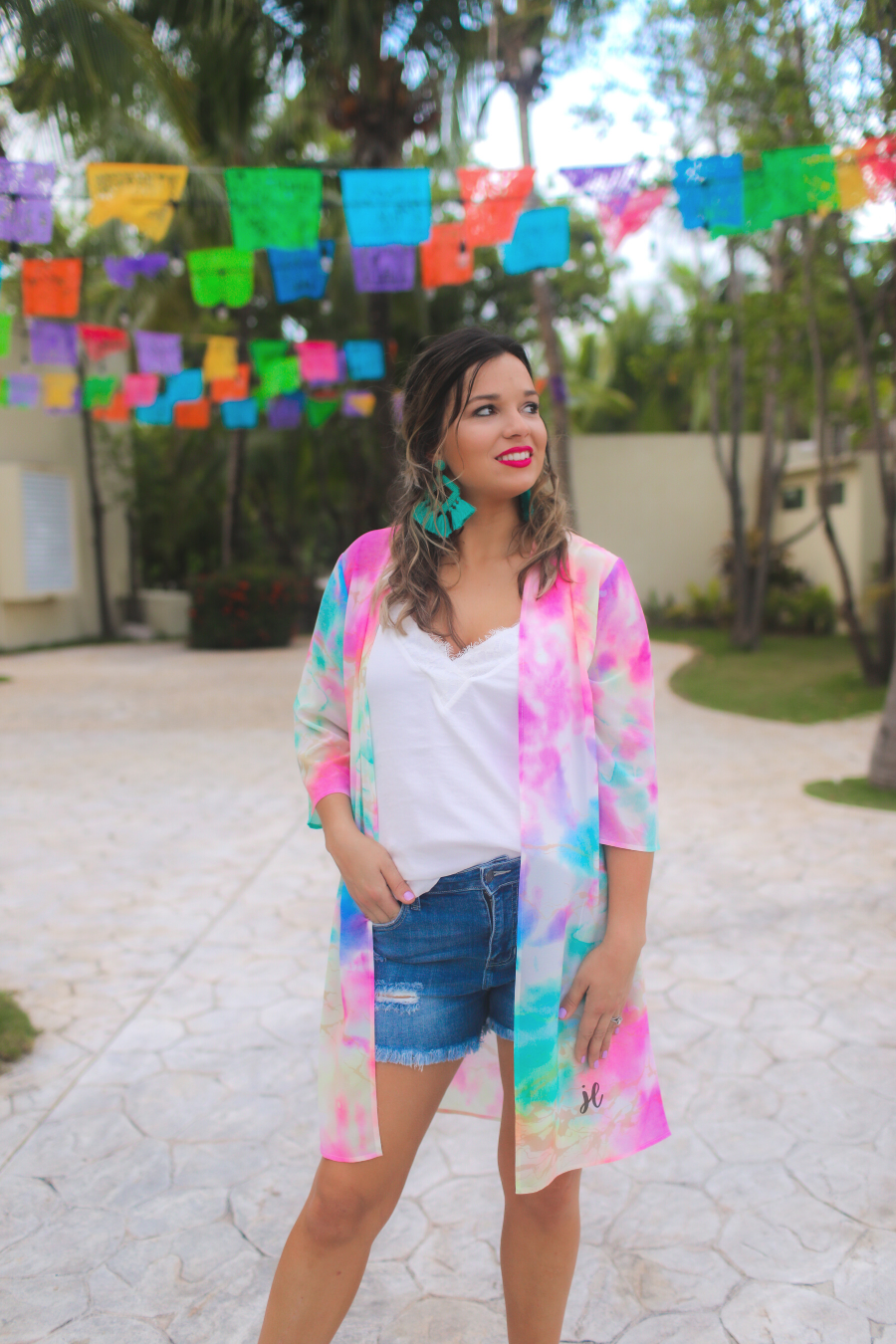 half-sleeve open front kimono made of lightweight material with a relaxed fit on a multi-colored tie-dye print pattern fabric