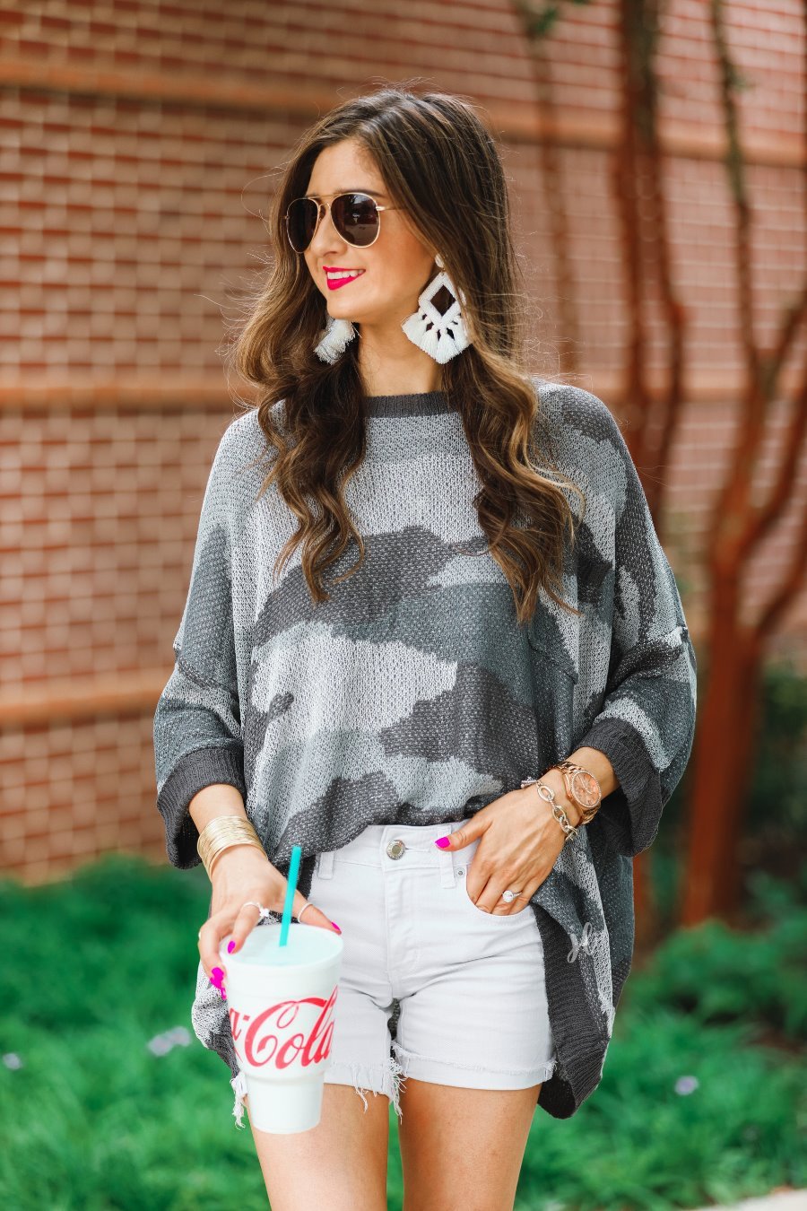 three-quarter cuffed sleeve unlined sweater crafted from a loose knit material with an oversized fit, a rounded neckline, a chest pocket, and trim on the collar, hem, and pocket on a grey camouflage pattern and charcoal base