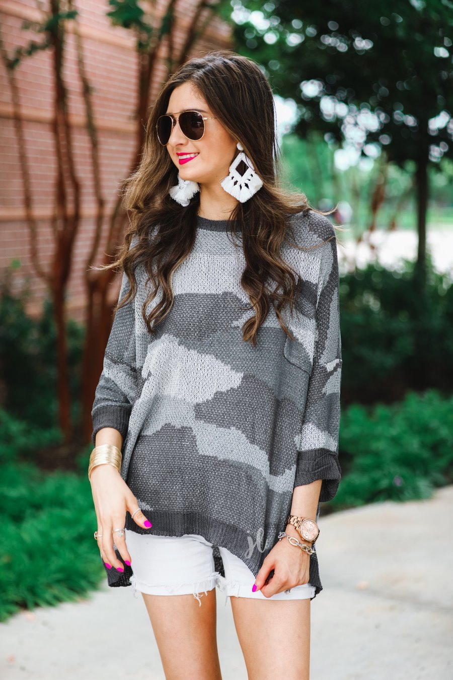 three-quarter cuffed sleeve unlined sweater crafted from a loose knit material with an oversized fit, a rounded neckline, a chest pocket, and trim on the collar, hem, and pocket on a grey camouflage pattern and charcoal base