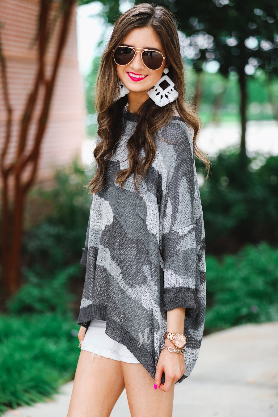 three-quarter cuffed sleeve unlined sweater crafted from a loose knit material with an oversized fit, a rounded neckline, a chest pocket, and trim on the collar, hem, and pocket on a grey camouflage pattern and charcoal base