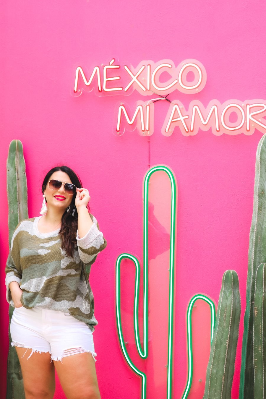 three-quarter cuffed sleeve unlined sweater crafted from a loose knit material with an oversized fit, a rounded neckline, a chest pocket, and trim on the collar, hem, and pocket on a green camouflage pattern and grey base