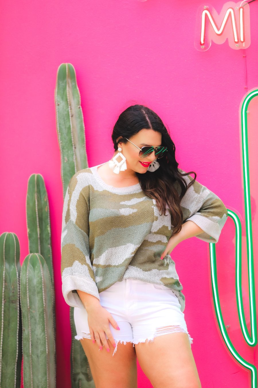 three-quarter cuffed sleeve unlined sweater crafted from a loose knit material with an oversized fit, a rounded neckline, a chest pocket, and trim on the collar, hem, and pocket on a green camouflage pattern and grey base