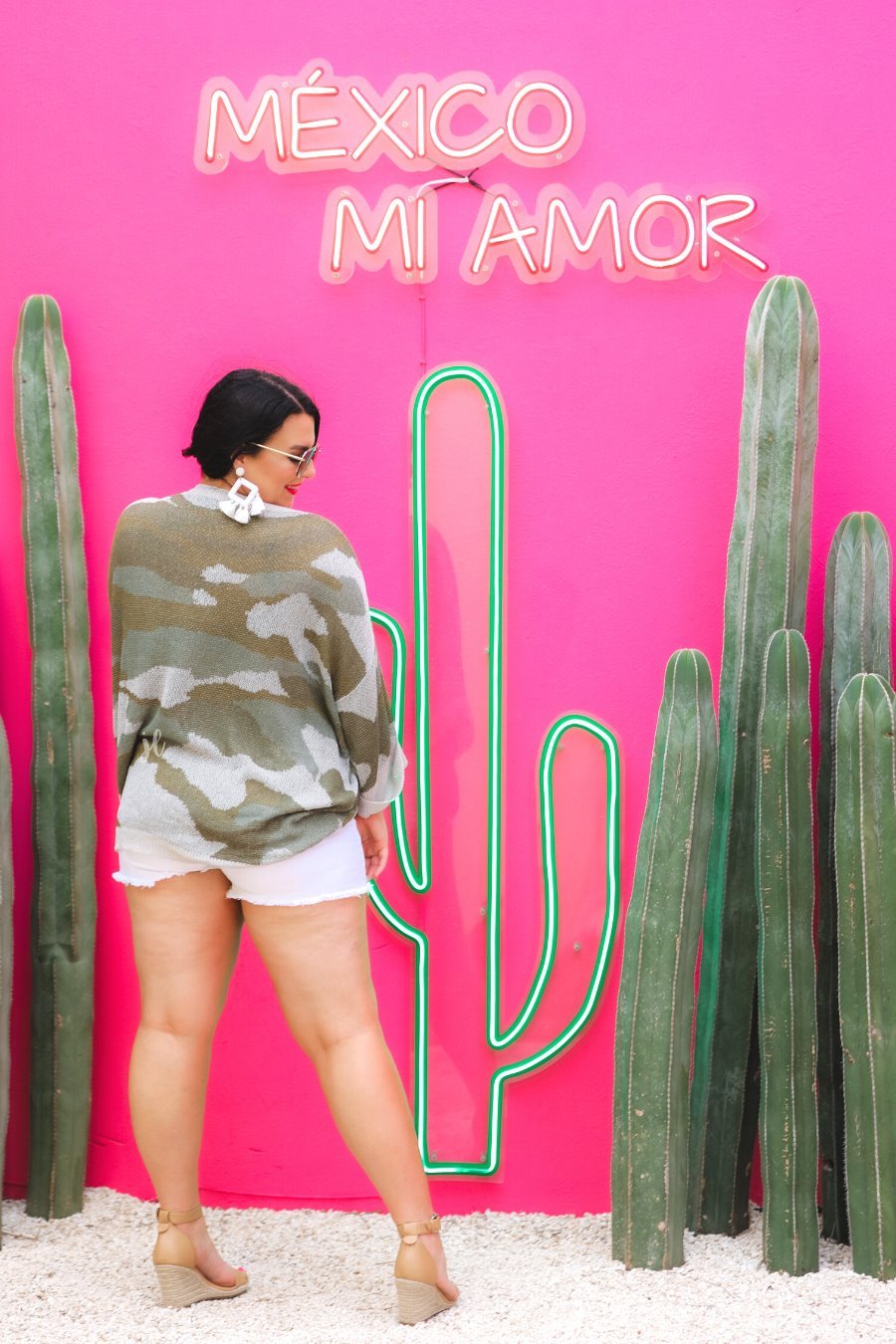 three-quarter cuffed sleeve unlined sweater crafted from a loose knit material with an oversized fit, a rounded neckline, a chest pocket, and trim on the collar, hem, and pocket on a green camouflage pattern and grey base