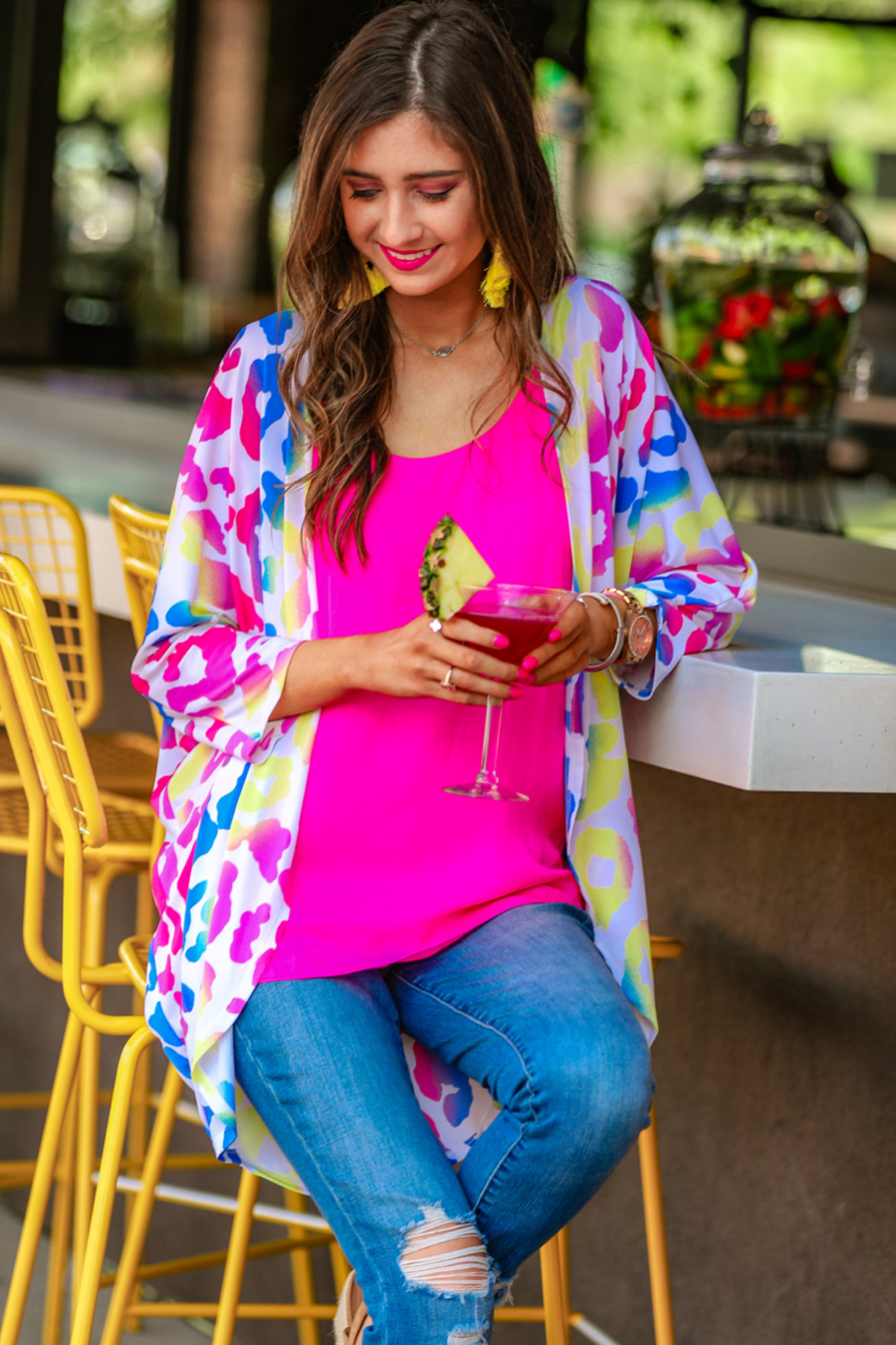 three-quarter sleeve open front cardigan made of lightweight material that drapes into a cocoon shape on a vibrant leopard print pattern fabric in white