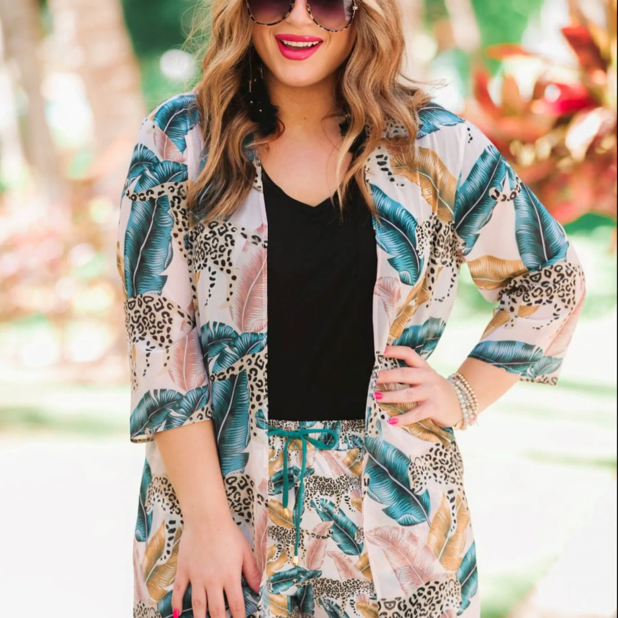 casual loose open front kimono made of lightweight material on a tiger and feather print pattern fabric with a light rose gold background