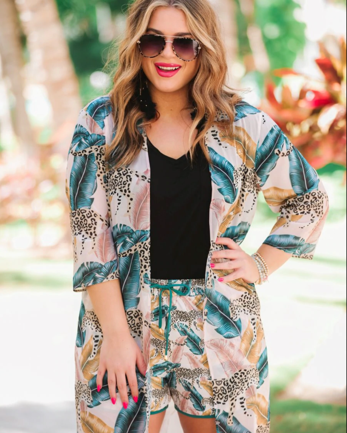 casual loose open front kimono made of lightweight material on a tiger and feather print pattern fabric with a light rose gold background