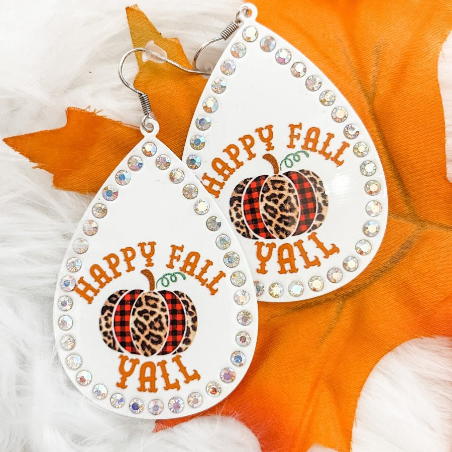 lightweight, seasonal-inspired leopard-theme teardrop-shaped earrings outlined in rhinestones with a fish hook in white leopard pumpkin