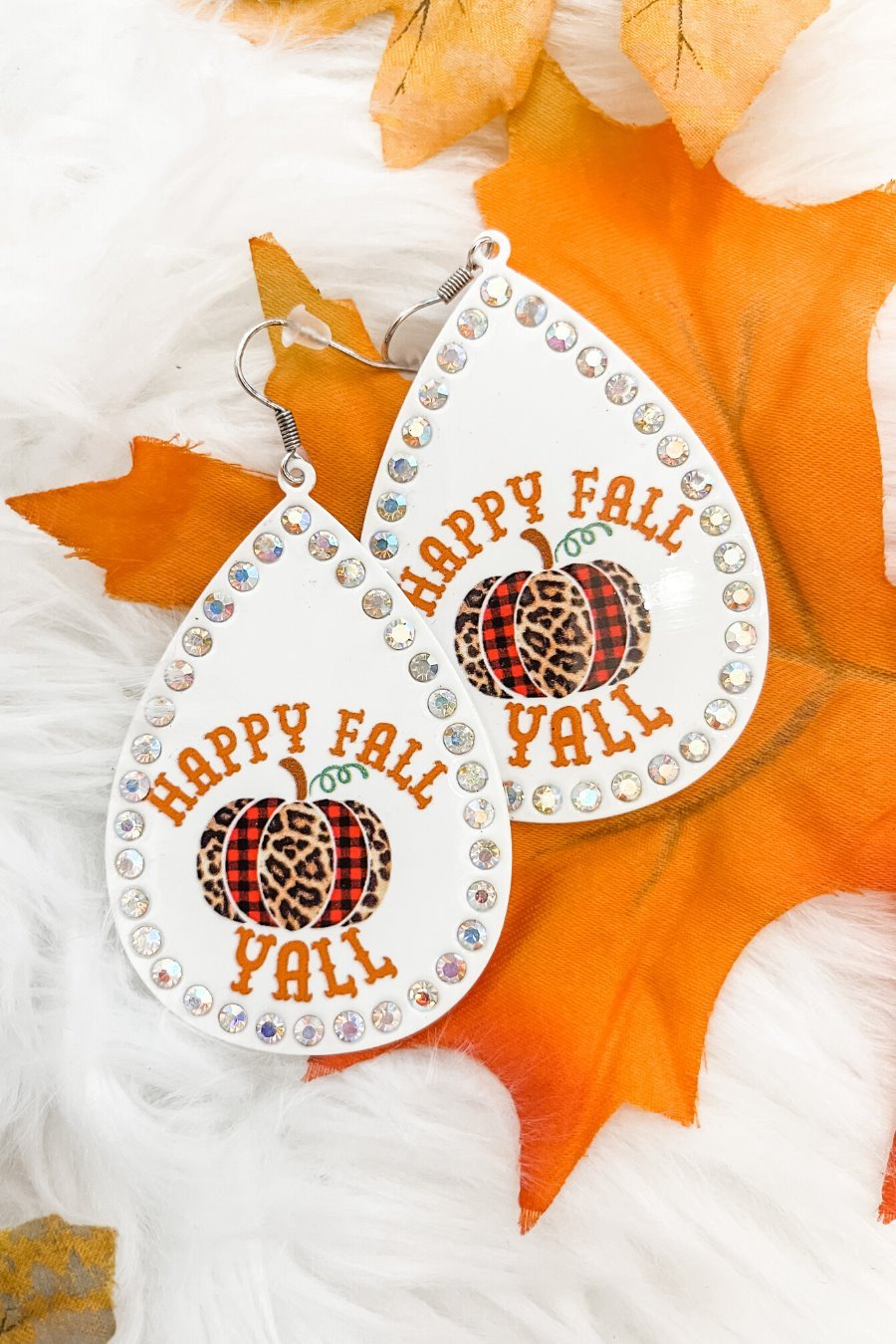 lightweight, seasonal-inspired leopard-theme teardrop-shaped earrings outlined in rhinestones with a fish hook in white leopard pumpkin