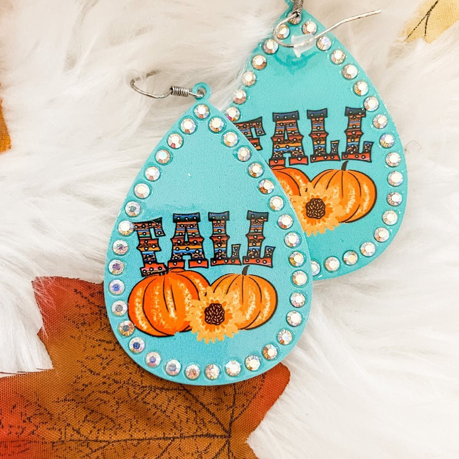 lightweight, seasonal-inspired leopard-theme teardrop-shaped earrings outlined in rhinestones with a fish hook in teal serape pumpkin