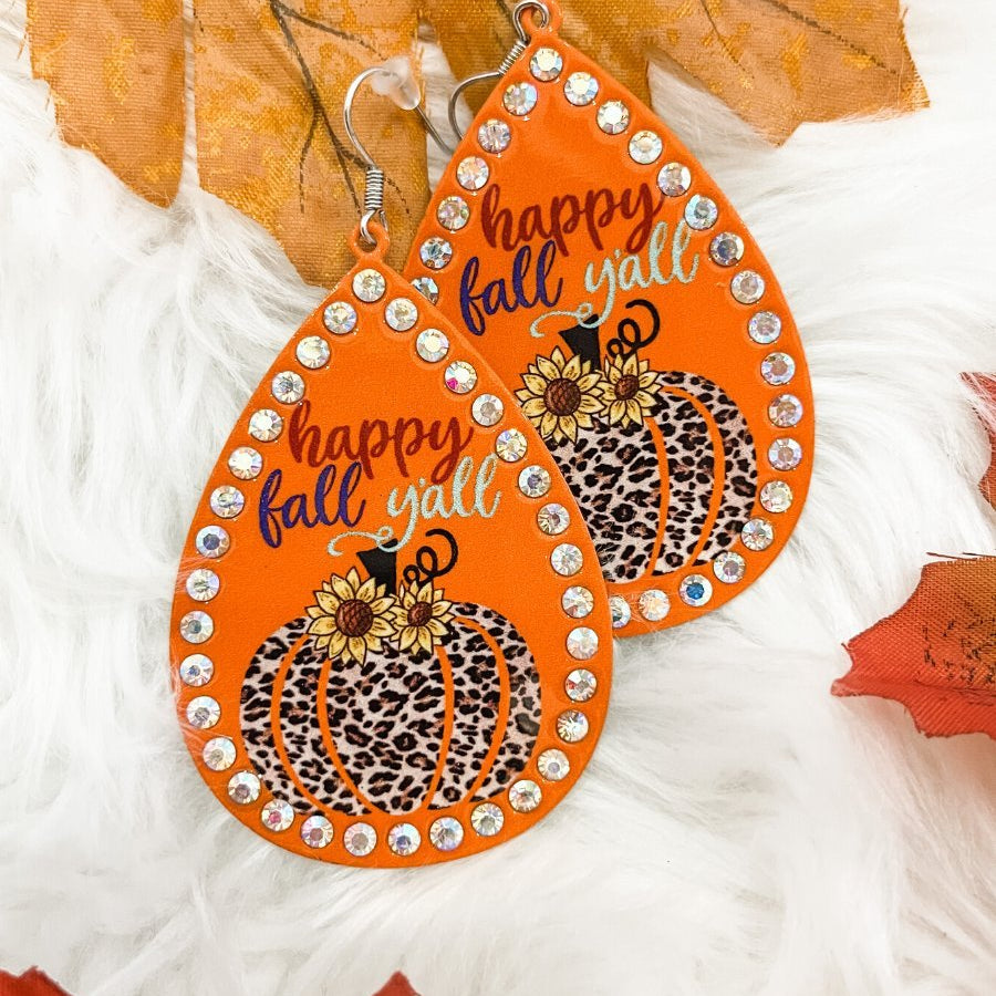 lightweight, seasonal-inspired leopard-theme teardrop-shaped earrings outlined in rhinestones with a fish hook in orange leopard pumpkin
