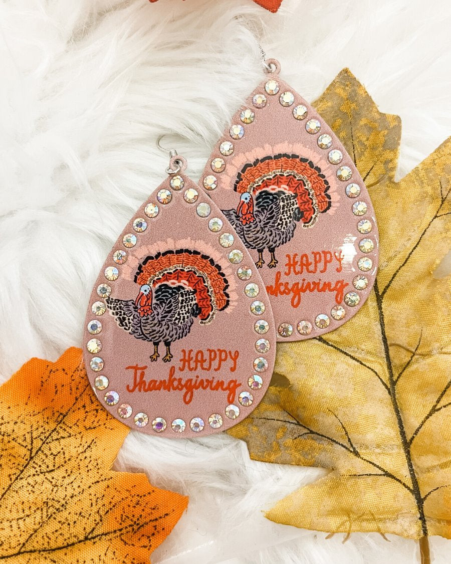 lightweight, seasonal-inspired leopard-theme teardrop-shaped earrings outlined in rhinestones with a fish hook in mauve leopard pumpkin