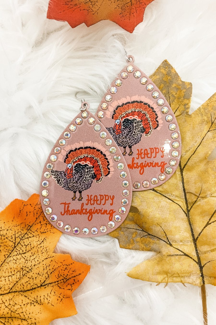lightweight, seasonal-inspired leopard-theme teardrop-shaped earrings outlined in rhinestones with a fish hook in mauve leopard pumpkin