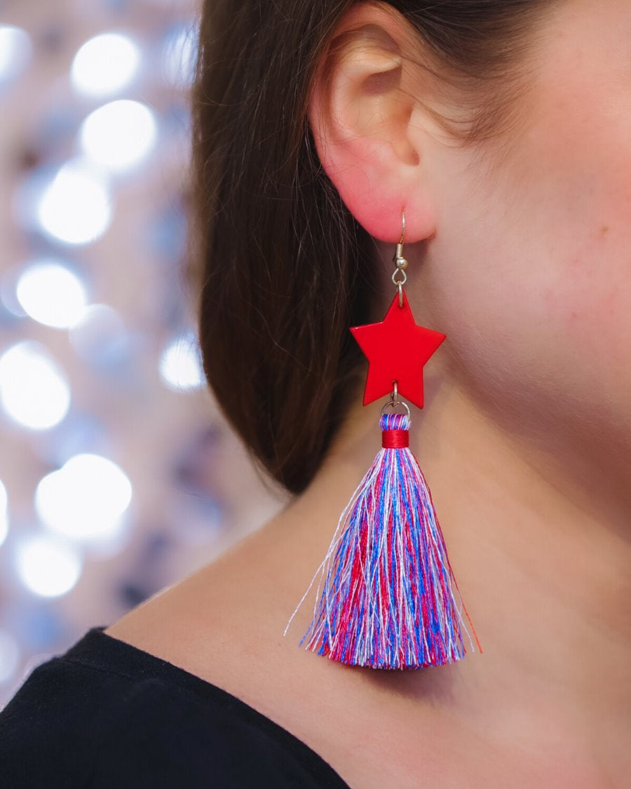 ultra-lightweight hook-style drop earring with a red star topper cascading down into a soft red, white, and blue tassel mix and gold accent
