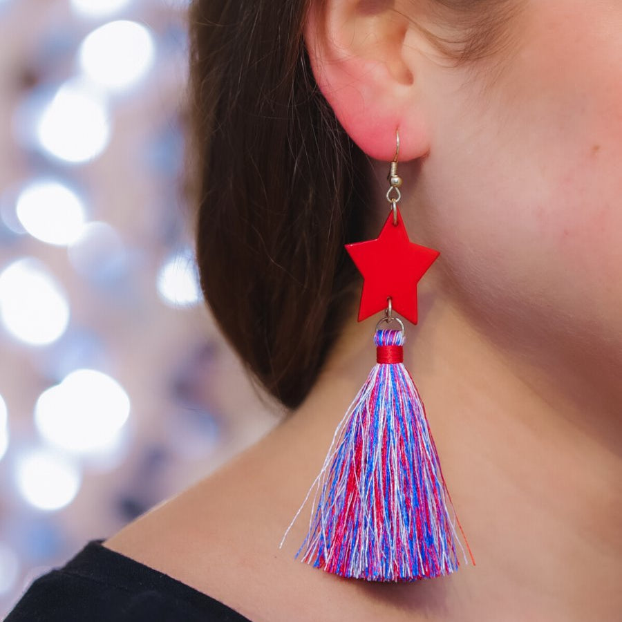 ultra-lightweight hook-style drop earring with a red star topper cascading down into a soft red, white, and blue tassel mix and gold accent