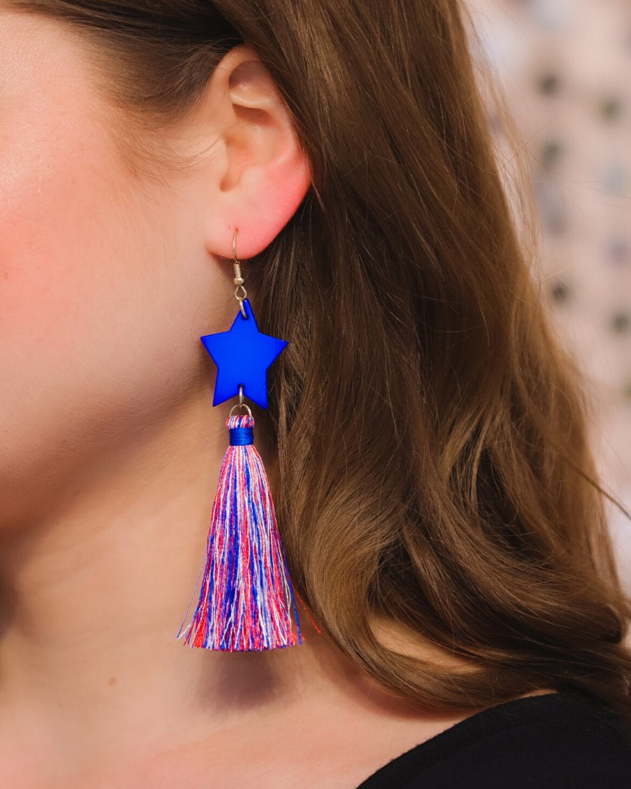 ultra-lightweight hook-style drop earring with a blue star topper cascading down into a soft red, white, and blue tassel mix and gold accent