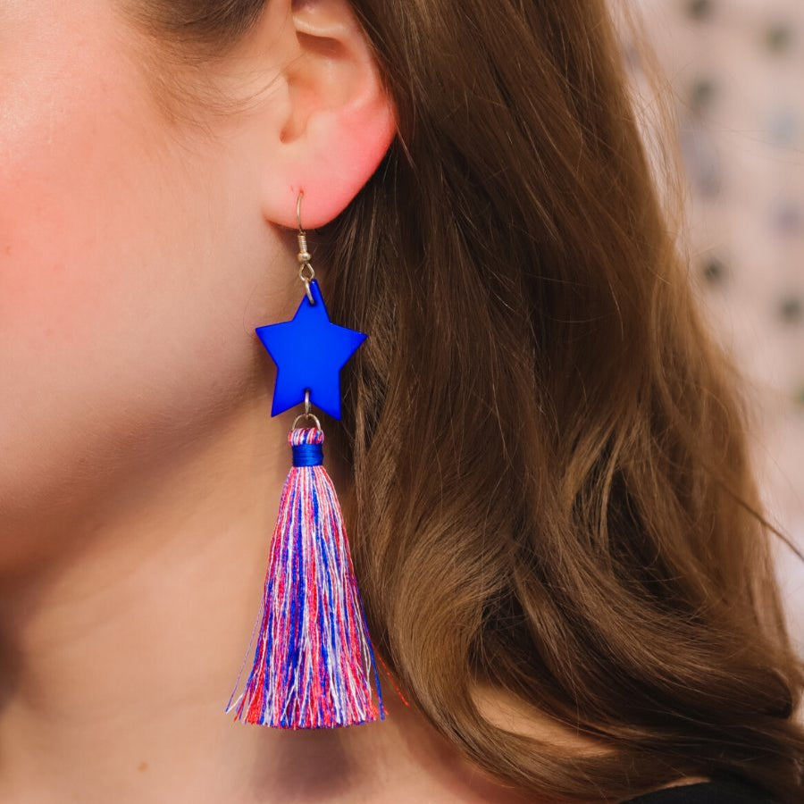 ultra-lightweight hook-style drop earring with a blue star topper cascading down into a soft red, white, and blue tassel mix and gold accent