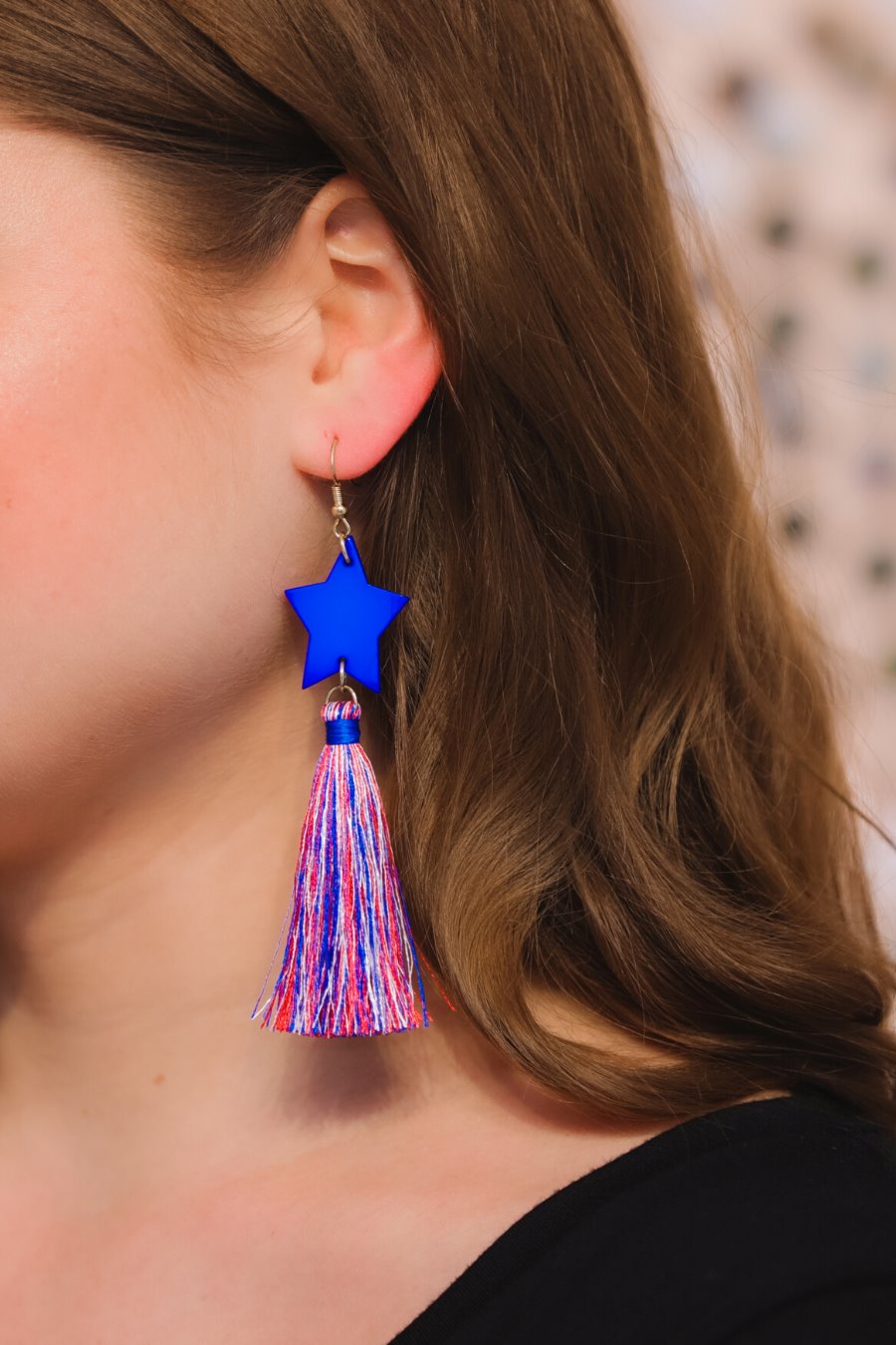 ultra-lightweight hook-style drop earring with a blue star topper cascading down into a soft red, white, and blue tassel mix and gold accent