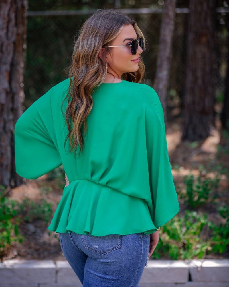 dolman long sleeves top with a plunging v-neckline and a gathered waistline in green