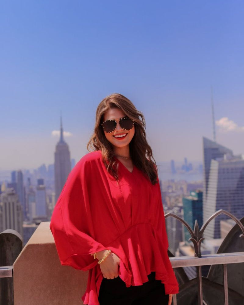 dolman long sleeves top with a plunging v-neckline and a gathered waistline in red