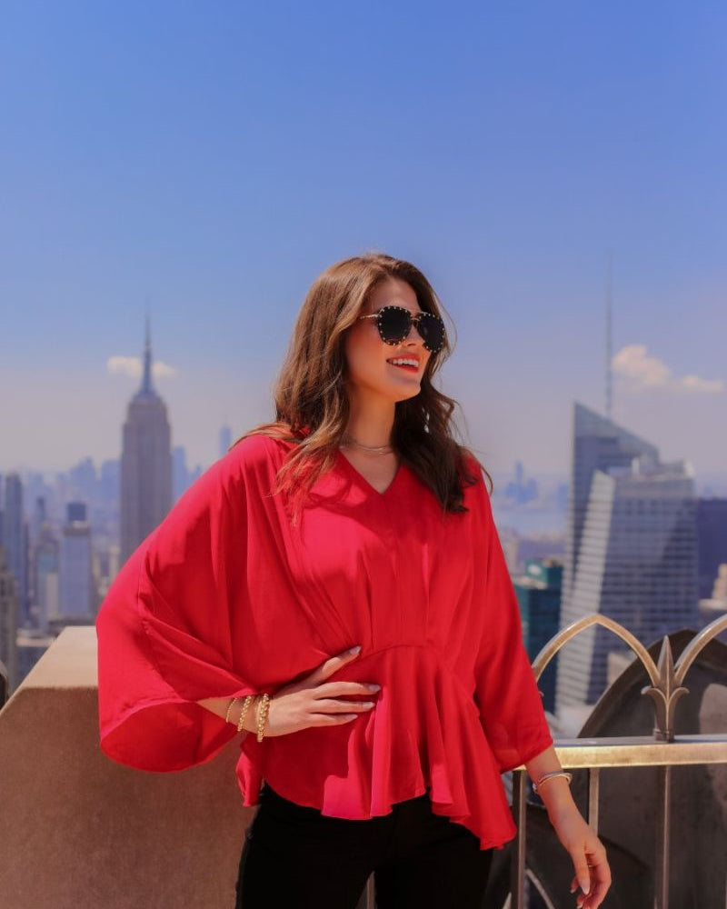 dolman long sleeves top with a plunging v-neckline and a gathered waistline in red