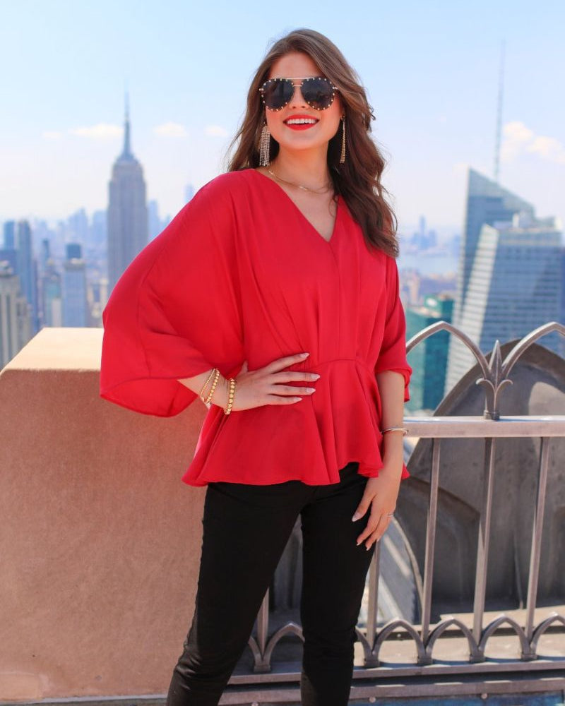 dolman long sleeves top with a plunging v-neckline and a gathered waistline in red