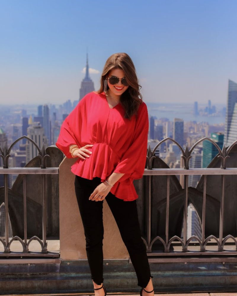 dolman long sleeves top with a plunging v-neckline and a gathered waistline in red