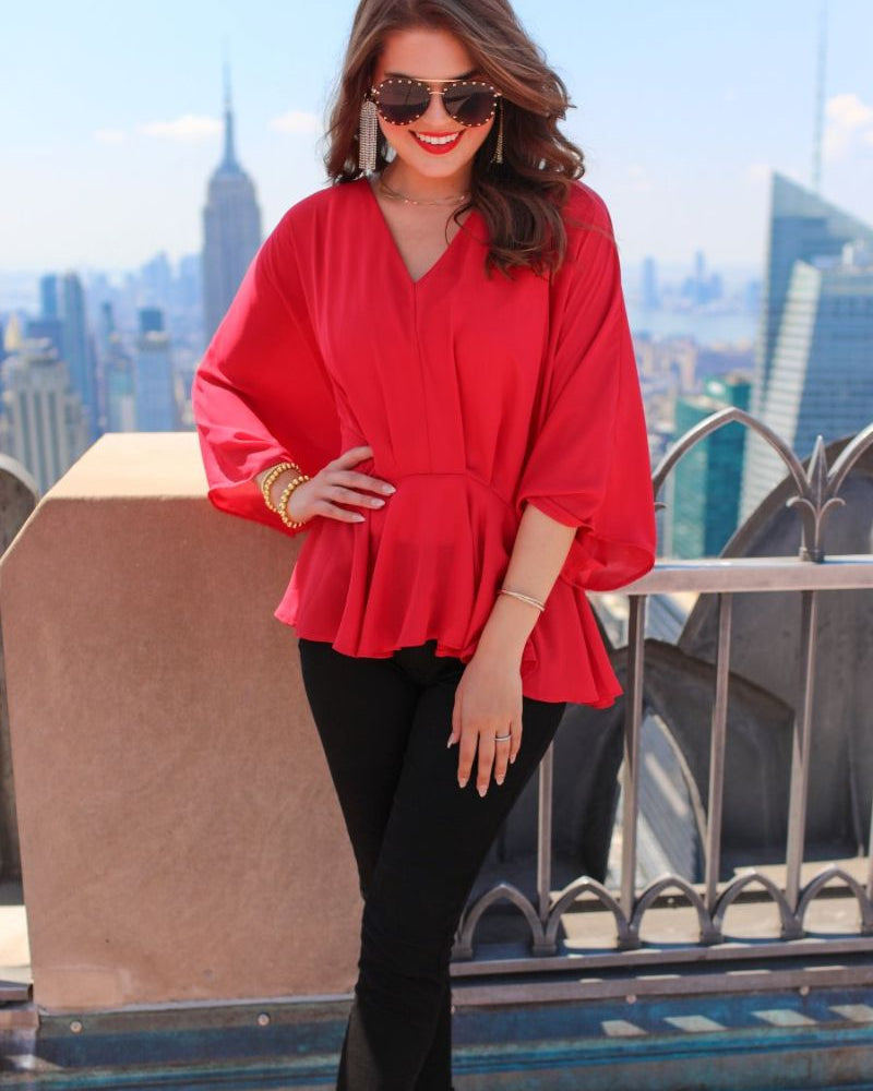 dolman long sleeves top with a plunging v-neckline and a gathered waistline in red