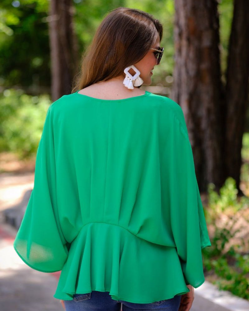 dolman long sleeves top with a plunging v-neckline and a gathered waistline in green