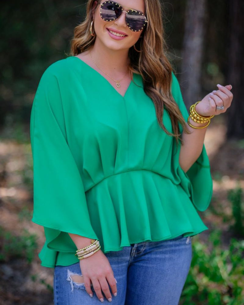 dolman long sleeves top with a plunging v-neckline and a gathered waistline in green