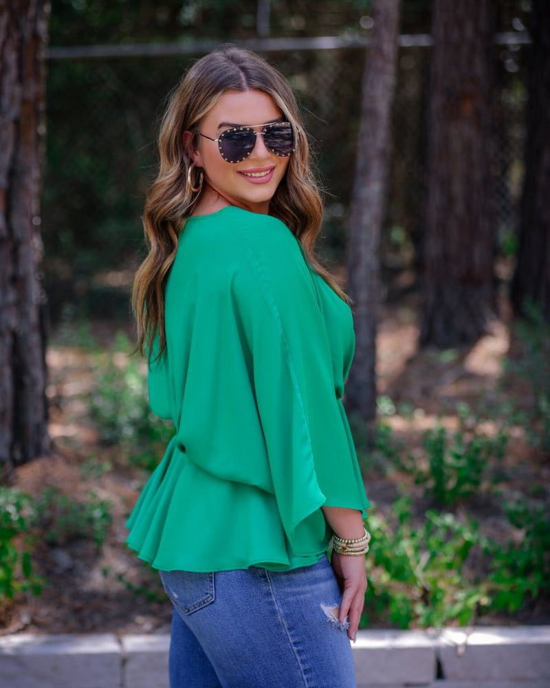dolman long sleeves top with a plunging v-neckline and a gathered waistline in green