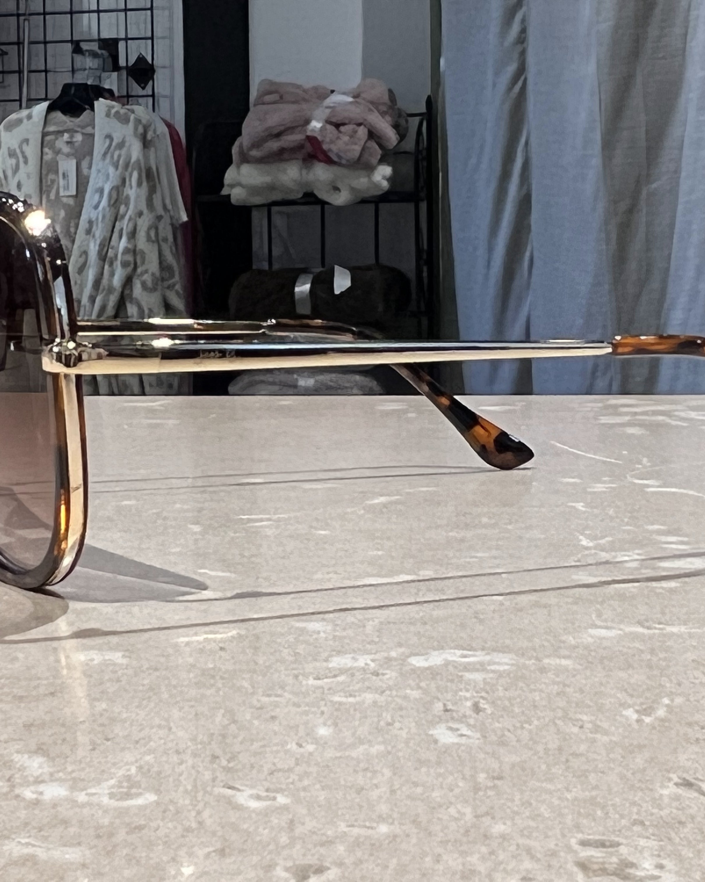 brown aviator sunglasses with thin round wireframes, tinted lenses, UV protection, and brand name detail (on both the temple and the complimentary black pouch)