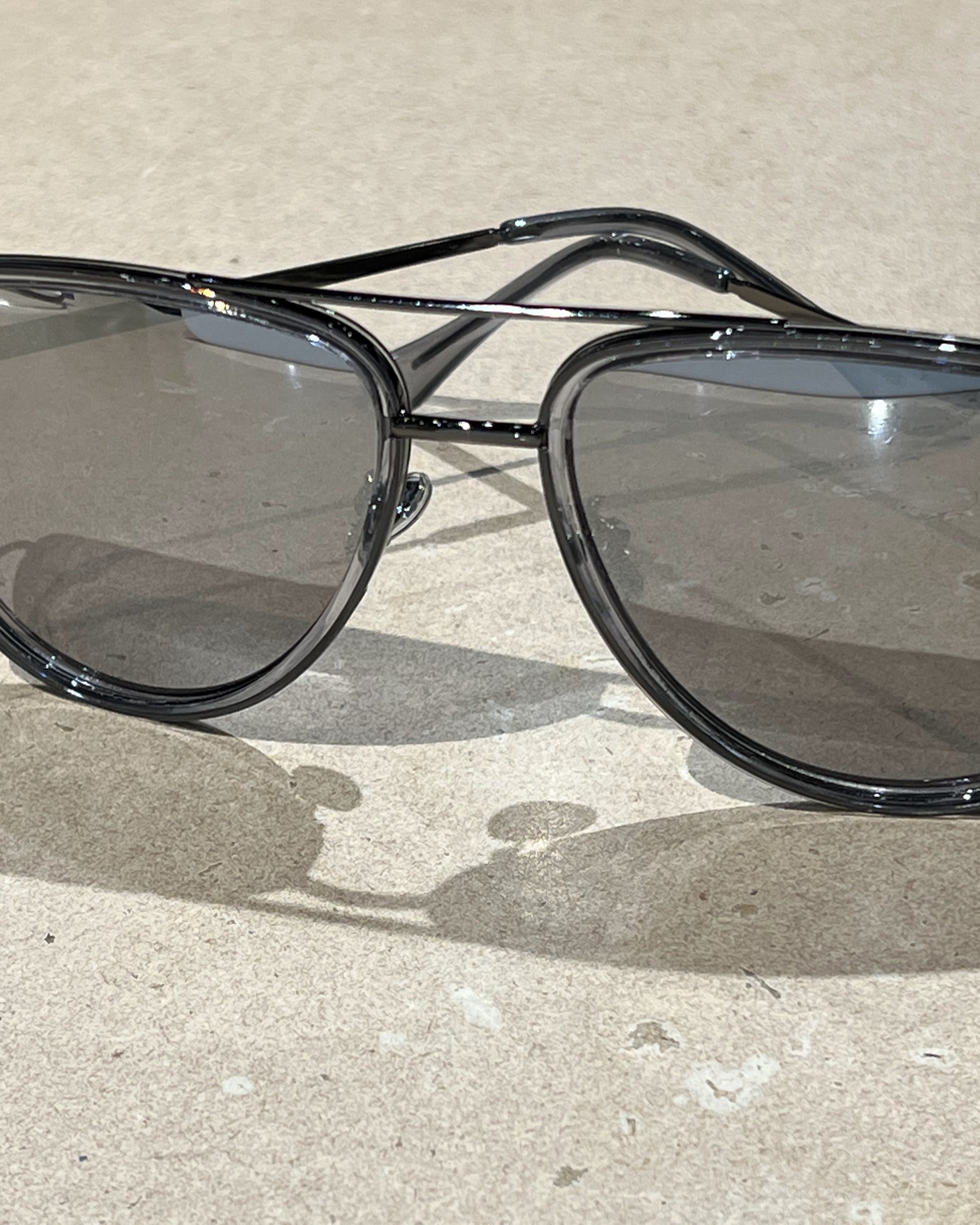 silver aviator sunglasses with thin round wireframes, tinted lenses, UV protection, and brand name detail (on both the temple and the complimentary black pouch)