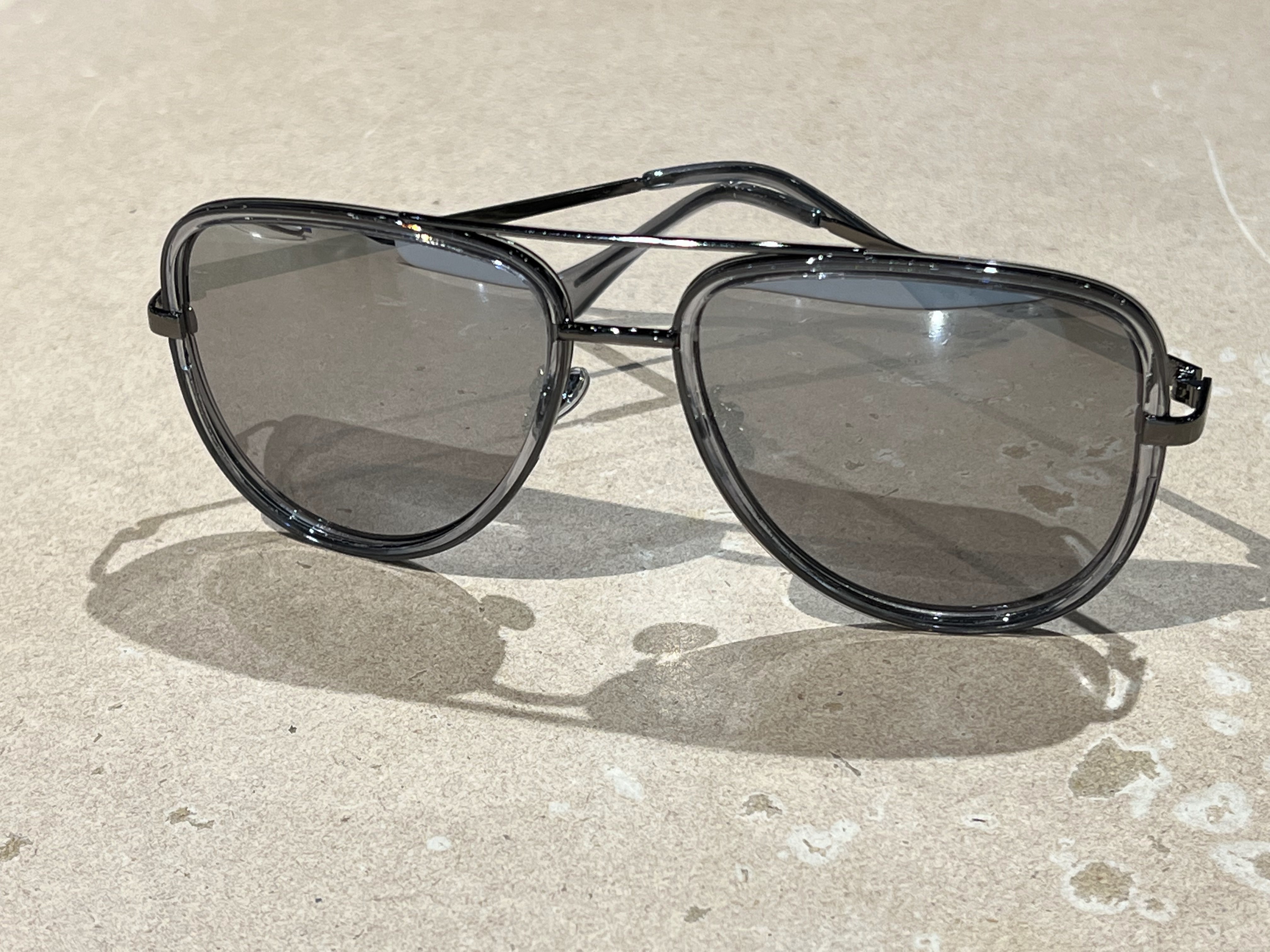 silver aviator sunglasses with thin round wireframes, tinted lenses, UV protection, and brand name detail (on both the temple and the complimentary black pouch)