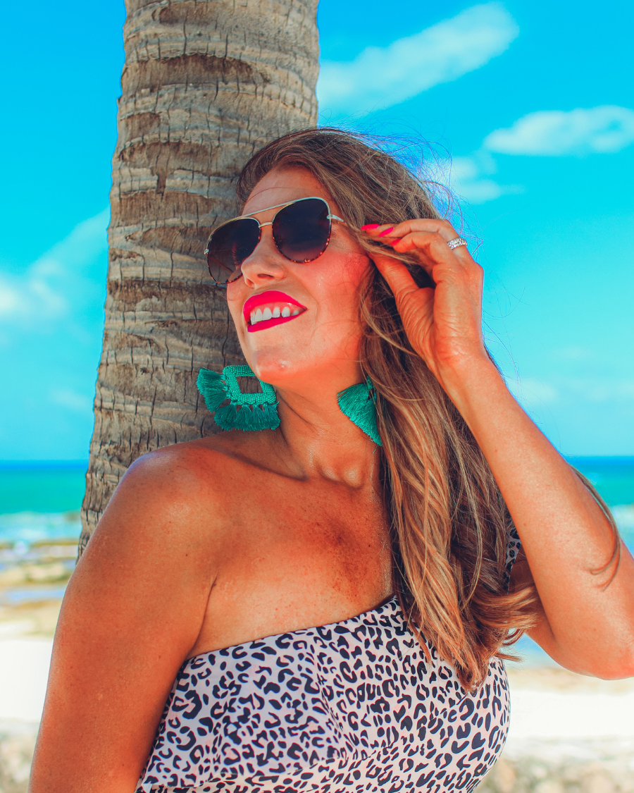 brown aviator sunglasses with tinted lenses, round wireframes with matching brow bar, leopard-patterned accents, UV protection, and brand detail (on both the temple and the complimentary black pouch)