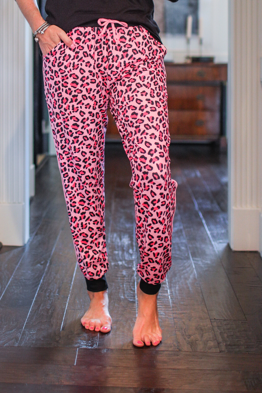 relaxed fit mid-rise joggers with side pockets and a tie waist drawstring, designed on a pink leopard pattern print