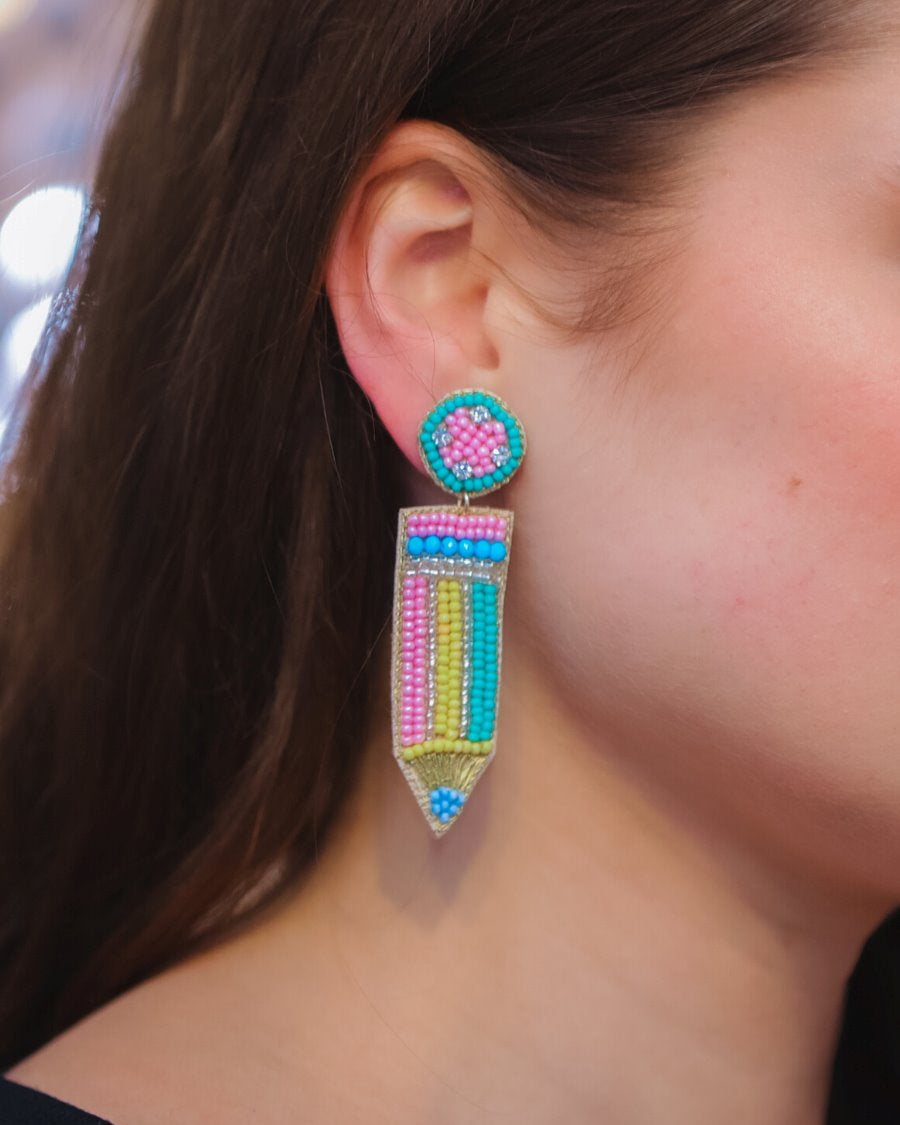 pencil-shaped stud earrings made of colorful beading and rhinestones with a felt backing, a comfort back earring, and a plastic disc stopper in gold