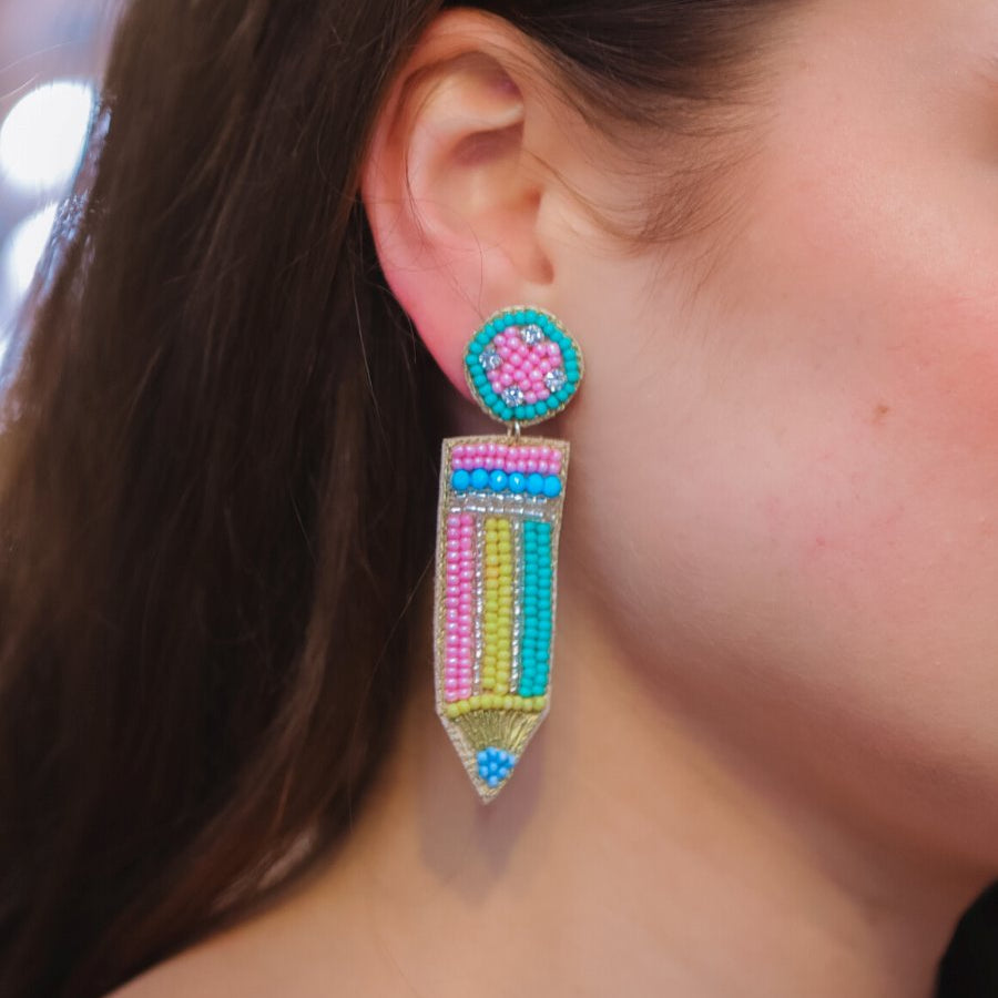 pencil-shaped stud earrings made of colorful beading and rhinestones with a felt backing, a comfort back earring, and a plastic disc stopper in gold
